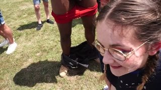 Fit young woman with 25 guys in a public stadium